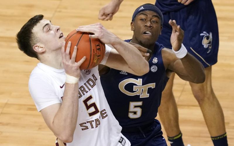 Georgia Tech forward Moses Wright (5) defends as Florida State center Balsa Koprivica (5) heads to the basket during the ACC Tournament championship game on Saturday in Greensboro, N.C. (GERRY BROOME/Associated Press)