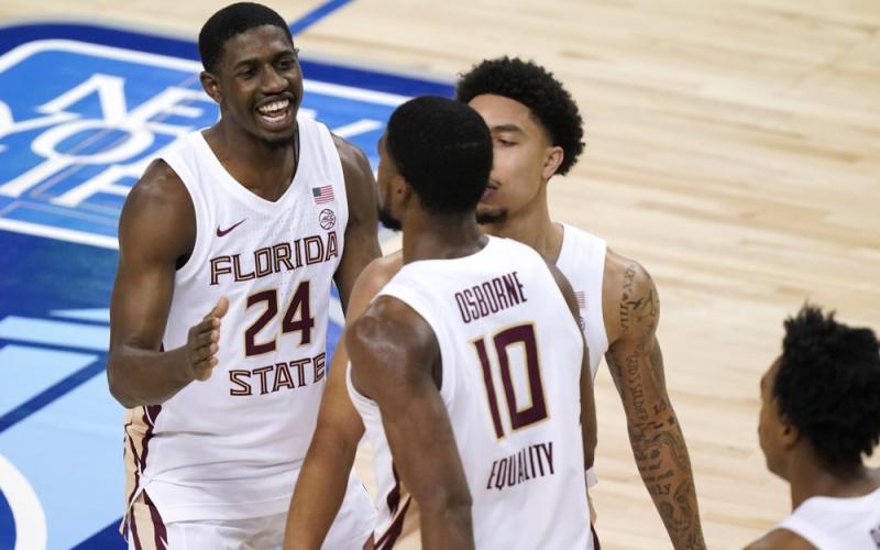 Florida State guard Sardaar Calhoun (24) and teammate guard Nathanael Jack (11) congradulate forward Malik Osborne (10) on a basket against North Carolina in the semifinal round of the ACC Tournament in Greensboro, N.C.. (GERRY BROOME/Associated Press)