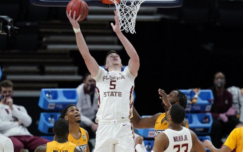 Florida State's Balsa Koprivica (5) puts back a rebound for a basket during the second half of a first-round game against UNC-Greensboro in the NCAA Tournament at Banker's Life Fieldhouse on Saturday in Indianapolis. Florida State defeated UNC-Greensboro 64-54. (DARRON CUMMINGS/Associated Press)