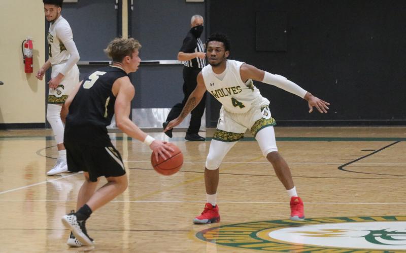 FGC guard Antonio Card defends Pasco-Hernando State College guard Hayden Greene during Saturday's FCSAA Region 8 Division II Championship at the Howard Center. (JORDAN KROEGER/Lake City Reporter)