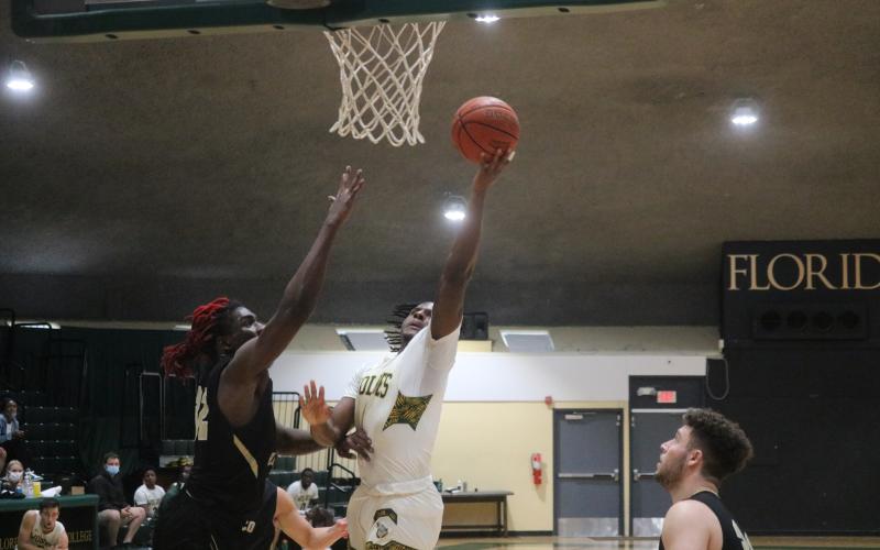 FGC guard Joshua Cross flies to the rim for a shot against Pasco-Hernando State College during Saturday's FCSAA Region 8 Division II Championship at the Howard Center. (JORDAN KROEGER/Lake City Reporter)