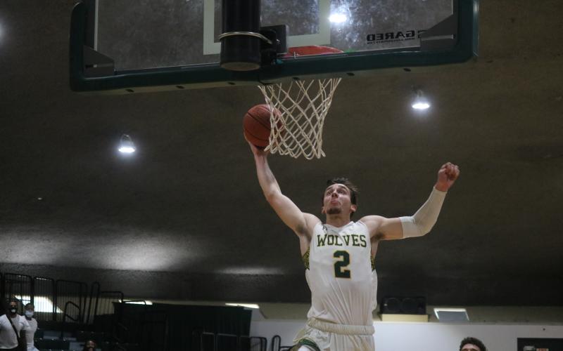 FGC forward Layton Veon soars for a dunk against Pasco-Hernando State College during Saturday's FCSAA Region 8 Division II Championship at the Howard Center. (JORDAN KROEGER/Lake City Reporter)
