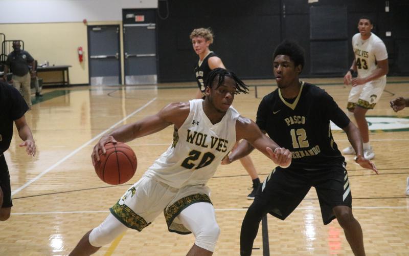 FGC forward Omari Jordan drives to the basket as Pasco-Hernando State College guard JaKeese Kemp defends during Saturday's FCSAA Region 8 Division II Championship at the Howard Center. (JORDAN KROEGER/Lake City Reporter)