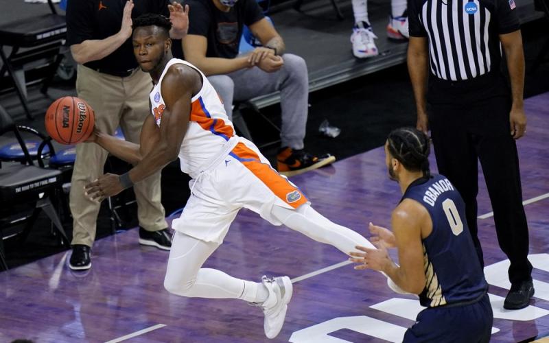 Florida forward Osayi Osifo, left, tries to save the ball from going out of bounds in front of Oral Roberts forward Kevin Obanor (0) during the second round of the NCAA Tournament at Indiana Farmers Coliseum on March 21 in Indianapolis. (AJ MAST/Associated Press)