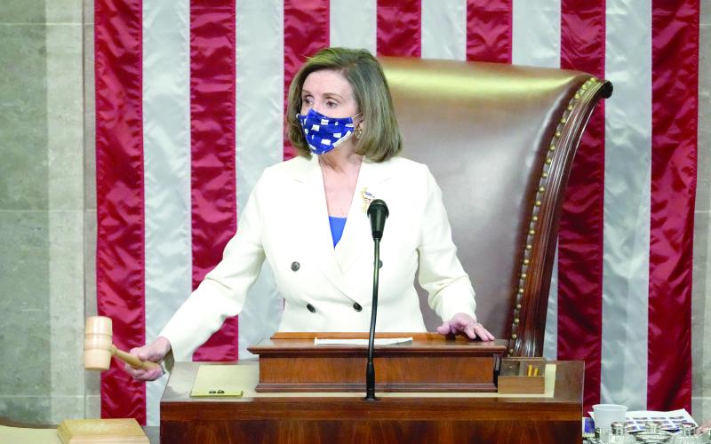 Speaker of the House Nancy Pelosi, D- Calif., raps her gavel after the House voted to pass the American Rescue Plan on Wednesday in Washington, D.C. (DREW ANGERER/Getty Images/TNS)