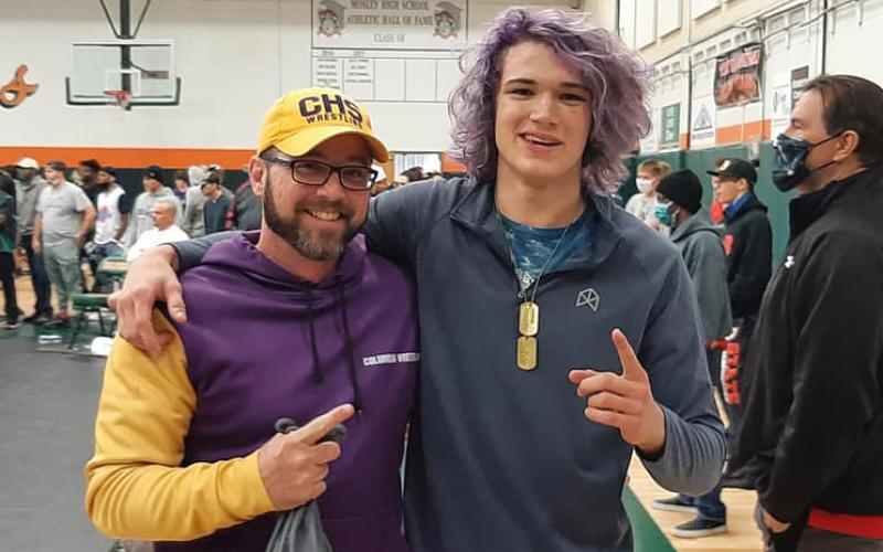 Columbia wrestler Joseph Rice (right) and coach Pete Whittington celebrate after Rice won the Region 1-2A title in the 170 weight class on Saturday. (COURTESY)