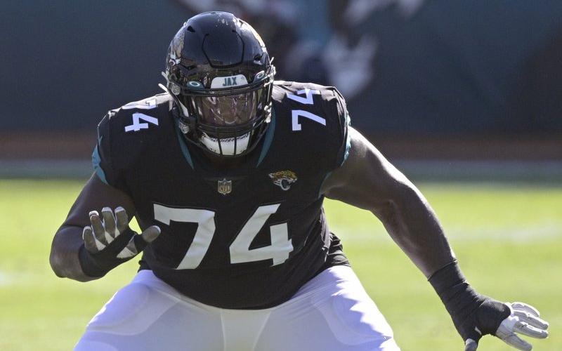 Jacksonville Jaguars offensive tackle Cam Robinson (74) sets up to block against the Chicago Bears on Dec. 27, 2020, in Jacksonville. The Jaguars are planning to use the franchise tag on left tackle Cam Robinson, preventing him from hitting the free-agent market and making him the blindside protector for presumptive No. 1 draft pick Trevor Lawrence. Coach Urban Meyer said Tuesday that “we are headed in that direction.” (AP FILE PHOTO)