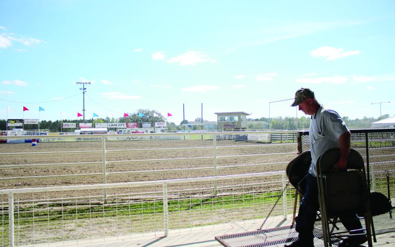 Ray Robinson sets up a row of chairs Wednesday afternoon while preparing the Florida Gateway Fairgrounds Rodeo Arena for the Florida Gateway Pro Rodeo, which takes place this weekend. (TONY BRITT/Lake City Reporter)