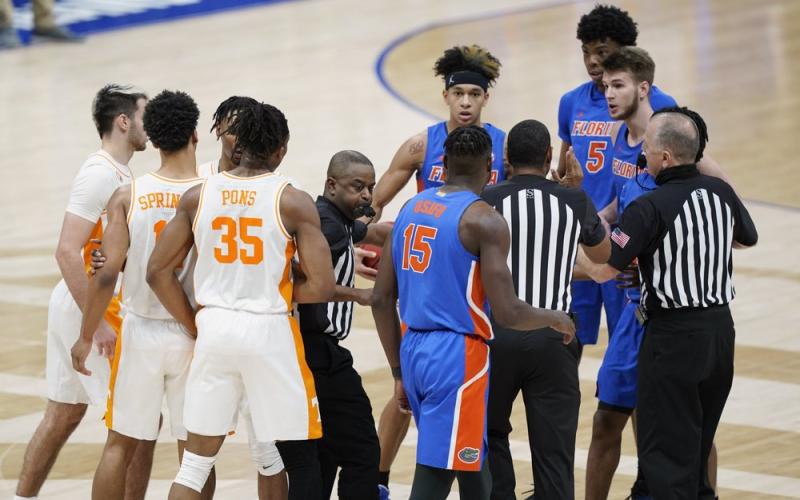 Tennessee and Florida players are separated after a foul by Florida's Omar Payne (5) in the second half of  the Southeastern Conference Tournament quarterfinals on Friday in Nashville, Tenn. Payne was ejected from the game after dealing a pair of elbows to John Fulkerson. (MARK HUMPHREY/Associated Press)