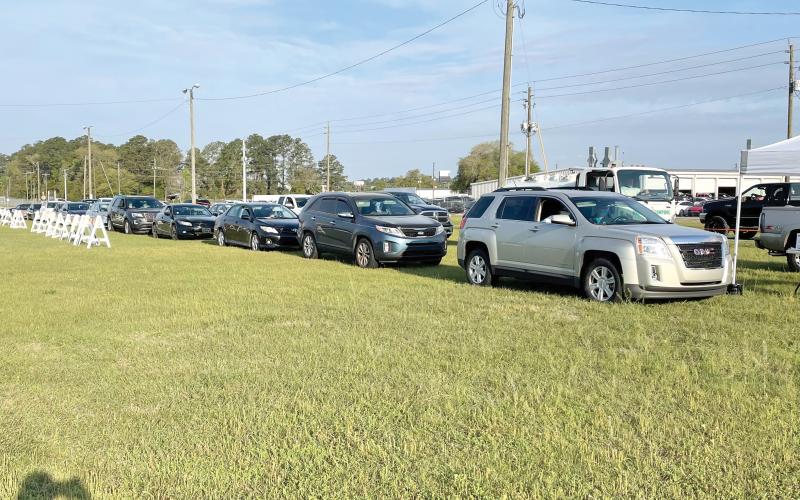 Vehicles line up Thursday morning at the Florida Gateway Fairgrounds parking lot to receive the covid-19 vaccine. (COURTESY)