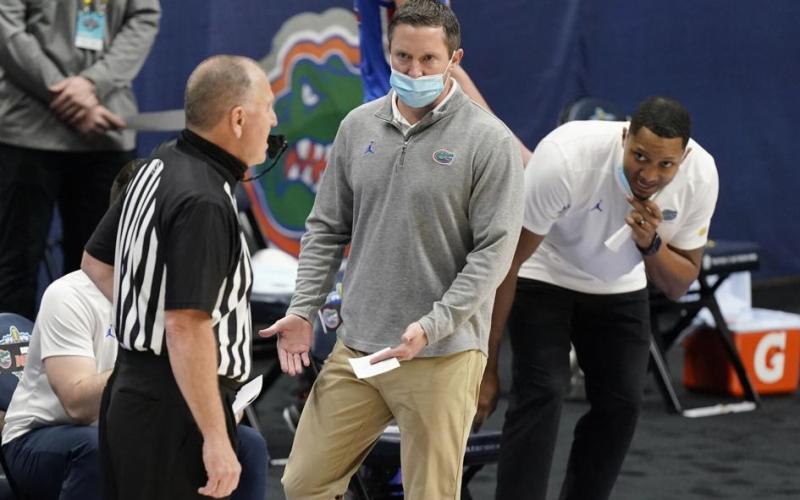 Florida head coach Mike White talks with an official in the first half of a game against Tennessee in the Southeastern Conference Tournament March 12 in Nashville, Tenn. (MARK HUMPHREY/Associated Press)