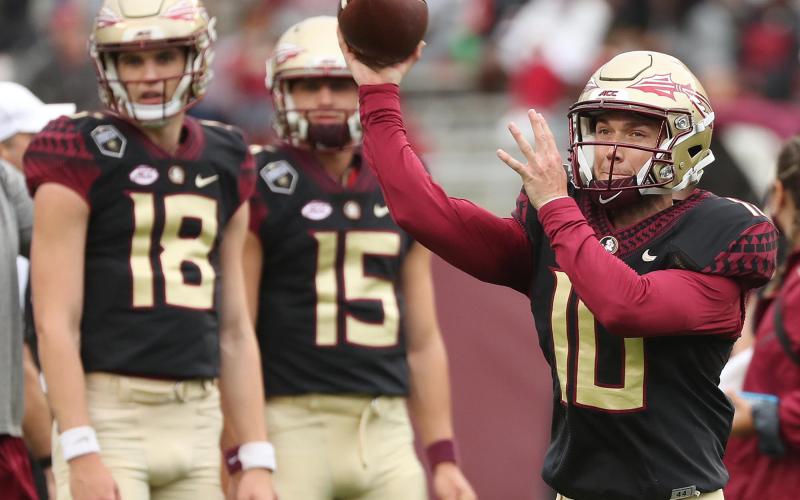 FSU quarterbacks Tate Rodemaker (18) and Gino English (15) watch quarterback McKenzie Milton (10) throw during the FSU Garnet &amp; Gold Spring Game at Doak Campbell Stadium on April 10 in Tallahassee. (STEPHEN M. DOWELL/Orlando Sentinel)