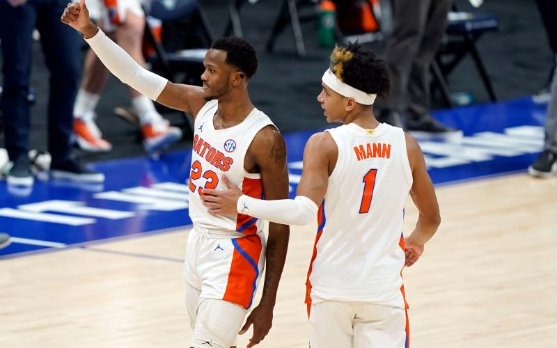 Florida's Scottie Lewis (23) and Tre Mann (1) leave the court after the Gators' win against Vanderbilt during the SEC Tournament last month. (MARK HUMPHREY/Orlando Sentinel/TNS)