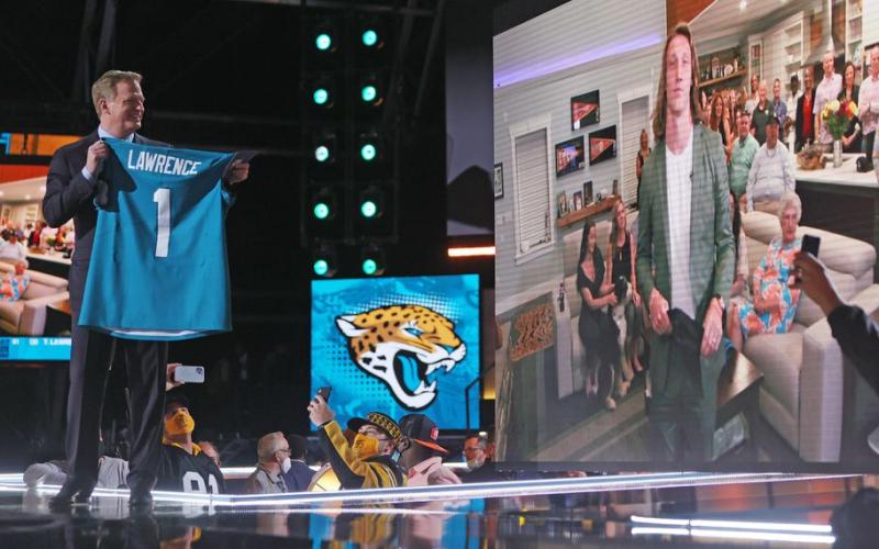 NFL Commissioner Roger Goodell congratulates quarterback Trevor Lawrence on being selected as the first pick in the 2021 NFL Draft by the Jacksonville Jaguars on Thursday in Cleveland. (JOHN KUNTZ/cleveland.com)