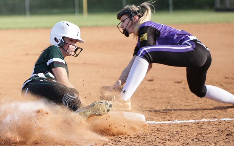 Suwannee pitcher Karis Smith beats the tag from Columbia third baseman Anissa Penniman to slide safely into third base during Tuesday night’s game. (BRENT KUYKENDALL/Lake City Reporter)