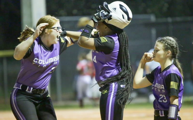 Columbia’s Hailey Bowmer (left) and Karis Jernigan celebrate after the Tigers’ 10-9 win over Bradford on Friday night. (BRENT KUYKENDALL/Lake City Reporter)