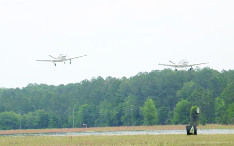 Two Beechcraft Bonanza airplanes take off from the Lake City Gateway Airport runway 10/28 on Friday afternoon. (TONY BRITT/Lake City Reporter)