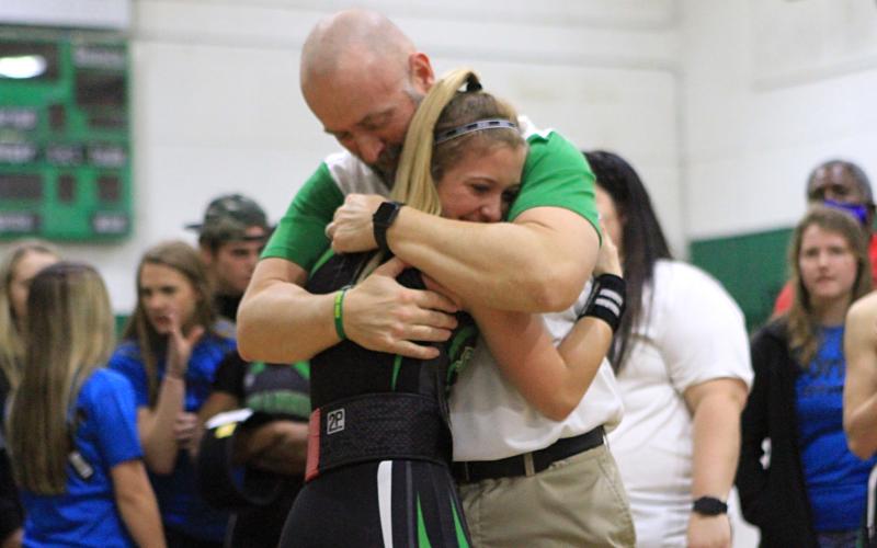 Suwannee weightlifter Matti Marsee hugs her father and assistant coach Dan Marsee after winning the Class 1A state title in the 110-pound weight class on Feb. 12. (PAUL BUCHANAN/Special to the Reporter)