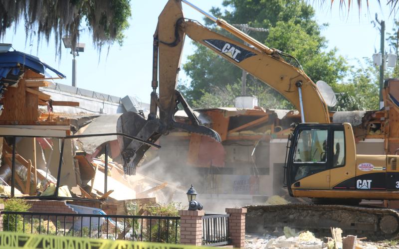 An unidentified employee from Dale’s Excavation uses an excavator to demolish the Burger King building at the intersection of West Duval Street and Southwest Main Boulevard Tuesday morning. Plans are for a new Burger King restaurant to be at the site within 30 days. (TONY BRITT/Lake City Reporter)