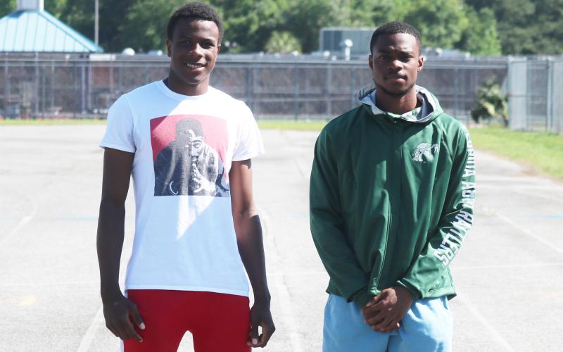 Columbia’s Seth Stockton (left) won a district title in the triple jump at Saturday’s District 2-3A meet, while James Williamson (right) won district crowns in the 100 and 200, breaking his own school record in the 200 by .03 seconds. (JORDAN KROEGER/Lake City Reporter)