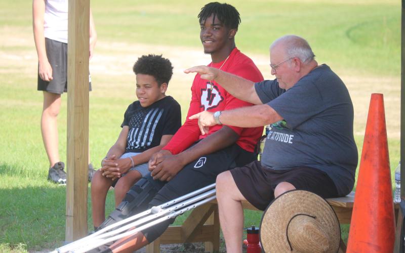 Fort White quarterback Tyler Jefferson watches practice from the sideline on Wednesday. Jefferson is out for all of spring practice after having knee surgery about six weeks ago. (JORDAN KROEGER/Lake City Reporter)