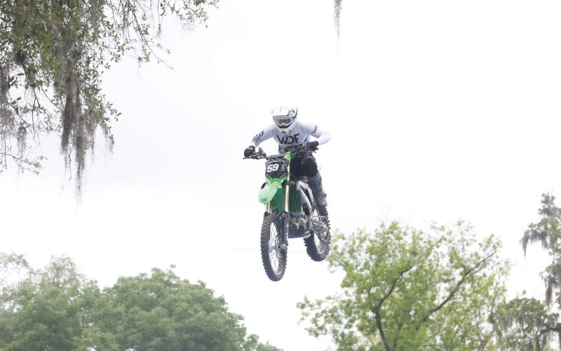 Team FMX rider Trevor Cartmill comes down on the landing ramp after jumping over Ellie Ray’s Bar at the Ellie Ray’s RV Resort &amp; Lounge on Saturday afternoon. (MORGAN MCMULLEN/Lake City Reporter)