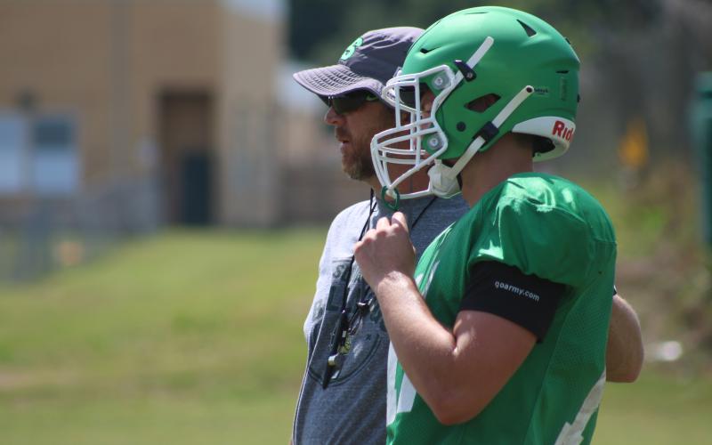 Suwannee quarterback Braxton Townsend listens to coach Kyler Hall during Thursday's practice. (JAMIE WACHTER/Lake City Reporter)