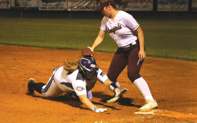 Columbia’s Alexis Blair is tagged out trying to slide back to first base against Madison County on Tuesday night. (MORGAN MCMULLEN/Lake City Reporter)