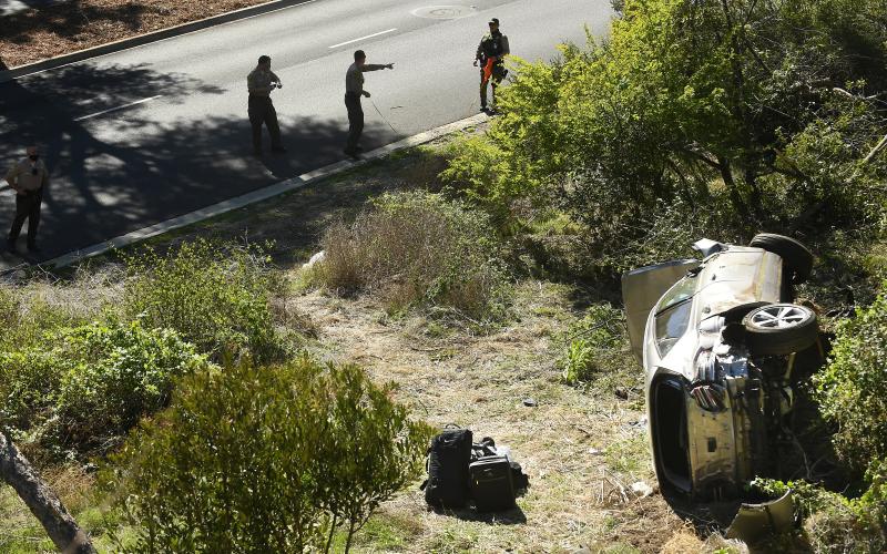 L.A. County Sheriff's officers investigate an accident involving golfer Tiger Woods along Hawthorne Boulevardon Feb. 23 in Rancho Palos Verdes, Calif. (WALLY SKALIJ/Los Angeles Times/TNS)