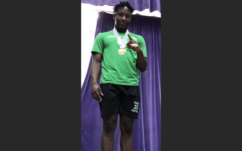 Suwannee’s Jaquez Moore celebrates on the podium after winning the Class 2A state title in the 183-pound weight class on Saturday. (COURTESY)