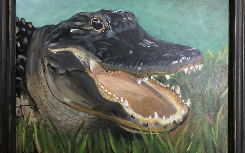 A framed painting of an alligator painted by Lara Wehrli during her six-week hiatus from her job as a dental hygienist will be part of an exhibit at Gateway Art Gallery starting Friday. (COURTESY)