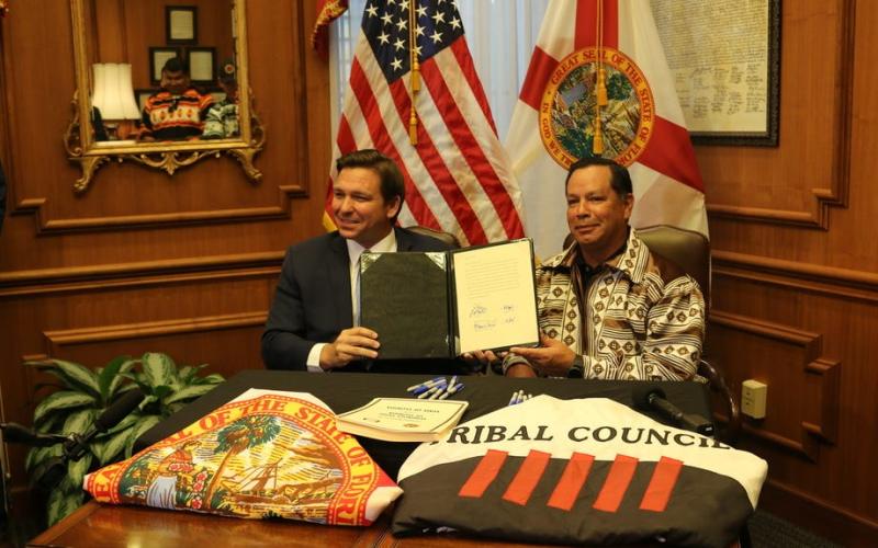 Gov. Ron DeSantis and Marcellus Osceola Jr., chairman of the Seminole Tribe of Florida, pose for a photo April 23 after signing a gambling compact. (MCT)
