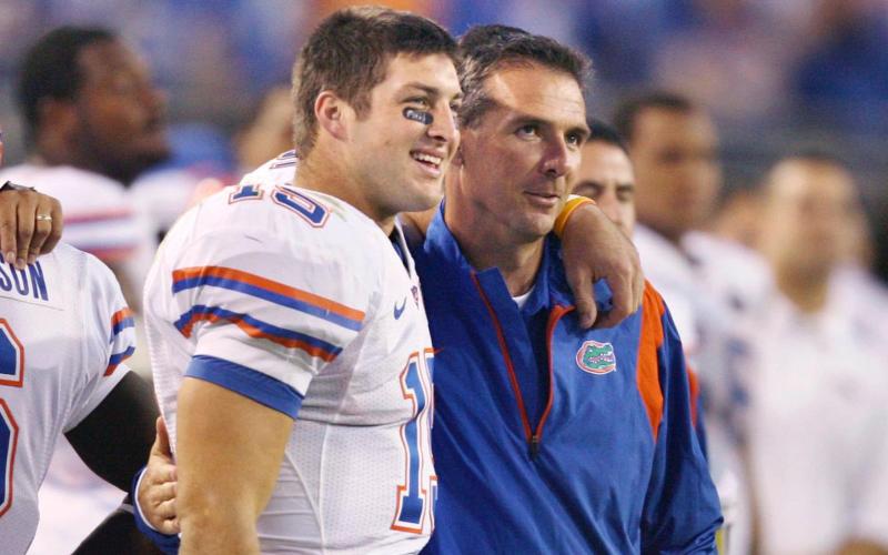 Florida quarterback Tim Tebow and head coach Urban Meyer share a moment together during a game against Georgia at Jacksonville Municipal Stadium on Nov. 1, 2008. (STEPHEN M. DOWELL/Orlando Sentinel/TNS)