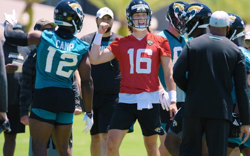 Jaguars quarterback Trevor Lawrence (16) talks with teammates during drills at rookie minicamp. (BOB SELF/Florida Times-Union/TNS)