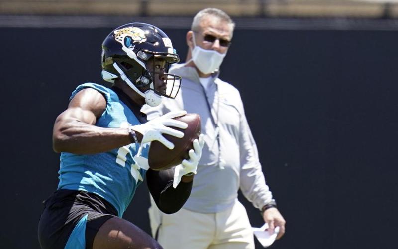 Jacksonville Jaguars wide receiver Jalen Camp, left, catches a pass as head coach Urban Meyer looks on during Saturday’s practice in Jacksonville. (JOHN RAOUX/Associated Press)