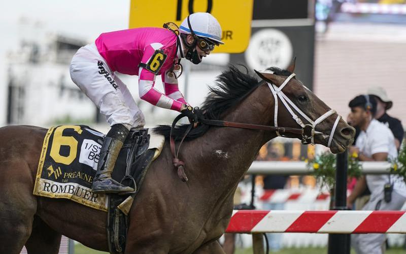 Flavien Prat atop Rombauer reacts as he crosses the finish line to win the Preakness Stakes horse race at Pimlico Race Course on Saturday in Baltimore. (JULIO CORTEZ/Associated Press)