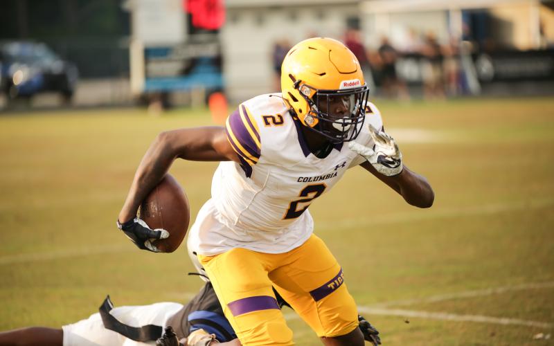 Columbia receiver Marcus Peterson races past a Bartram Trail defender after a catch Friday night in the Tigers’ spring game. (BRENT KUYKENDALL/Lake City Reporter)