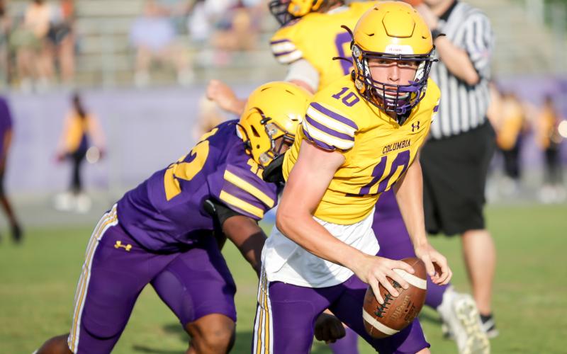 Columbia quarterback Kade Jackson scrambles away from pressure during last Friday’s Purple &amp; Gold game. (BRENT KUYKENDALL/Lake City Reporter)
