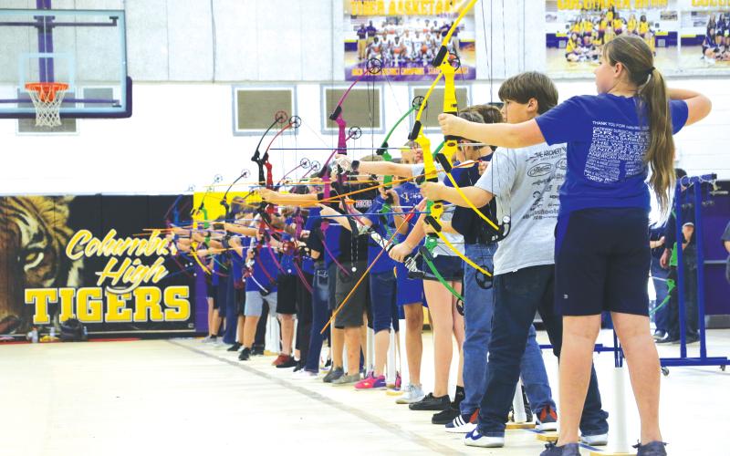 Students from Eastside, Westside and Pinemount Elementary schools line up their shots Friday afternoon in the NASP national tournament. (MORGAN MCMULLEN/Lake City Reporter)