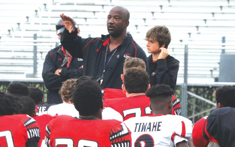 Fort White coach Demetric Jackson talks to his team following the Red &amp; Black game on Thursday. (MORGAN MCMULLEN/Lake City Reporter)
