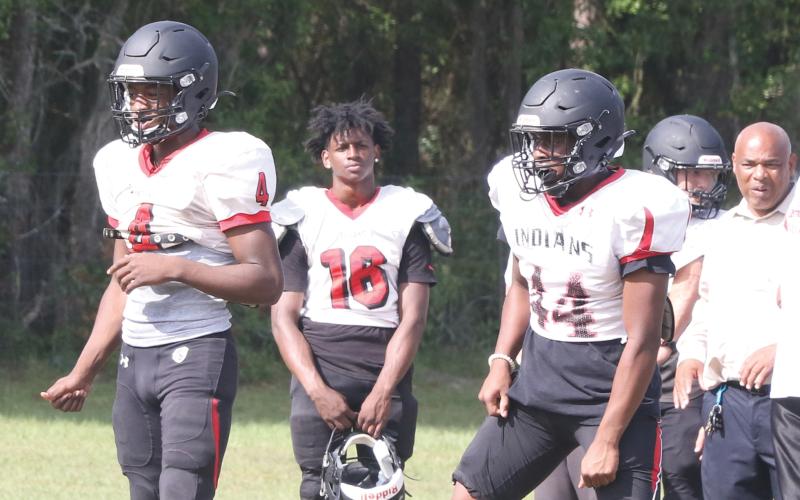 Fort White quarterback Darren Clark (left) and running back Jaylen Brown (right) line up in the shotgun during Tuesday’s practice. (MORGAN MCMULLEN/Lake City Reporter)