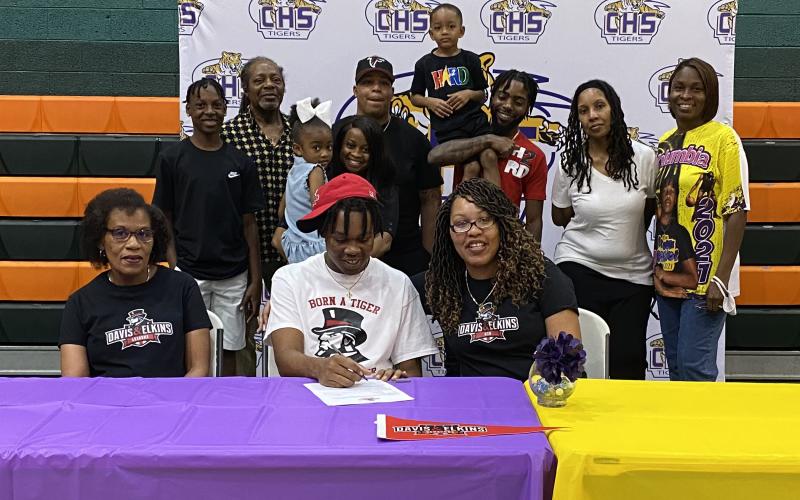 Columbia forward Charleston Ponds signs his letter of intent to play at Davis &amp; Elkins College earlier this month. (COURTESY)