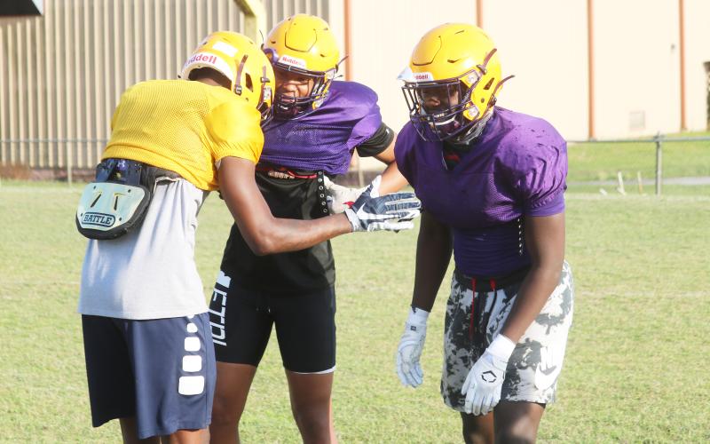 Columbia cornerback Amare Ferrell (middle) and linebacker Jaden Robinson (right) joke around with receiver Marcus Peterson after a play during practice on April 29. (JORDAN KROEGER/Lake City Reporter)