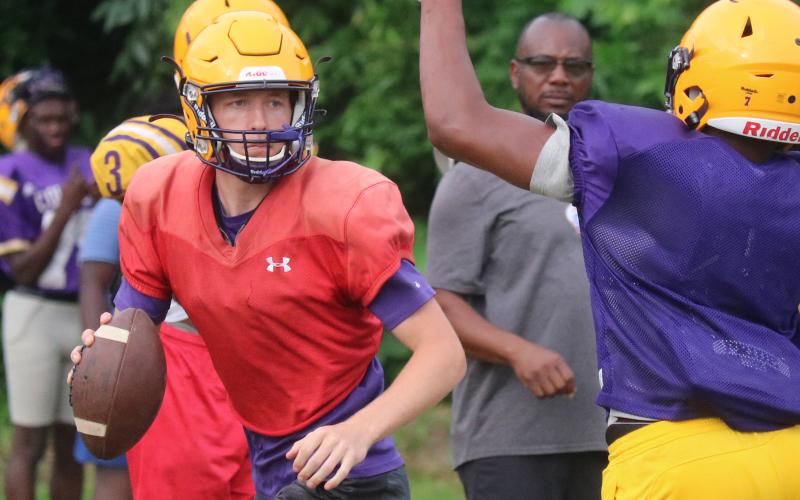 Columbia quarterback Kade Jackson scrambles away from pressure during Wednesday’s practice. (JORDAN KROEGER/Lake City Reporter)