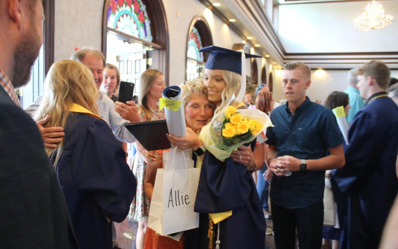 Pam Stuart (left) hugs her granddaughter Alexis Cady, following Belmont’s graduation ceremony. (TONY BRITT/Lake City Reporter)