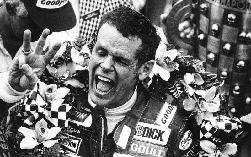 Bobby Unser holds three fingers aloft after winning his third Indianapolis 500 on May 24, 1981, in Indianapolis, Ind. Unser died of natural causes at his home on Sunday in Albuquerque, New Mexico. He was 87. (AP FILE PHOTO)
