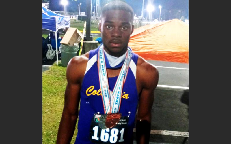 Columbia sprinter James Williamson is pictured with his two medals after placing third in the 100m and fourth in the 200m at the Class 3A state meet on Friday at the University of North Florida’s Hodges Stadium. (COURTESY)