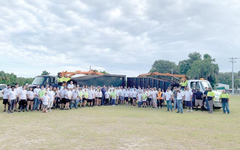 City workers and volunteers pose for a picture before beginning the inaugural county-wide cleanup day work on Saturday morning. Nearly 100 volunteers from Christ Central Ministries participated in the inaugural effort. (COURTESY)