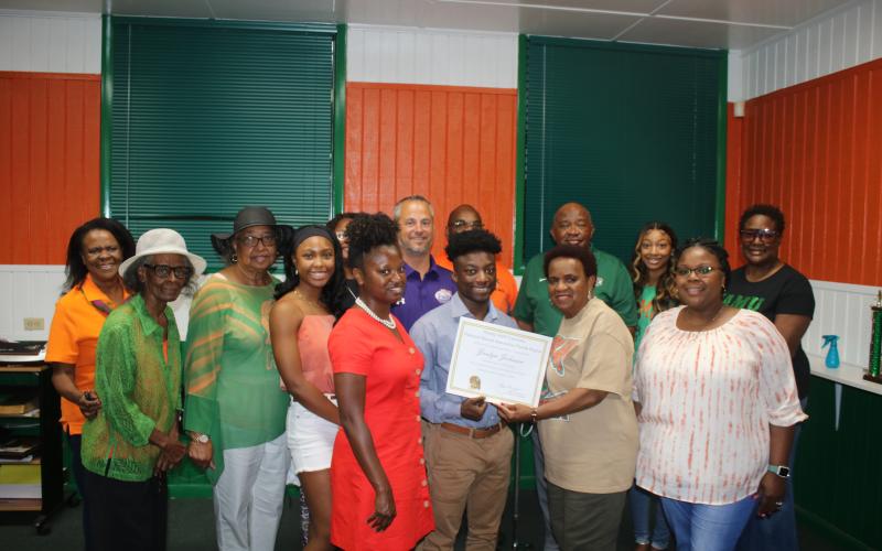 Nicole Newton (front row, from left), Jordyn Johnson, Annie Brooks (Columbia County president of the FAMU Alumni Association) and Trisheka Nelson. (Back row, from left) Pam Miller, Arleen Lofton Poitier, Corrine Lofton, Tonita Orr, Nyla Sams, Trey Hosford, Al Nelson, Mario Coppock, Aniya  Timmons and Evette Watson pose for a photograph during the Jordyn Johnson FAMU scholarship award ceremony. (TONY BRITT/Lake City Reporter)