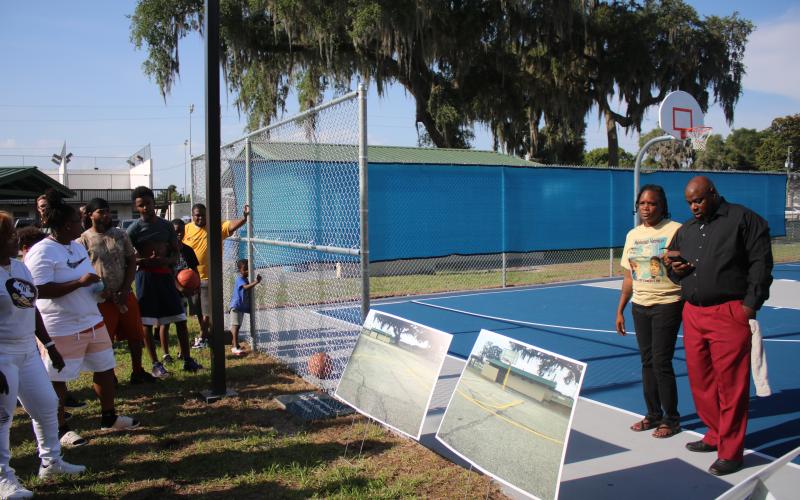 Angela Harrison and Preston Owens (far right), mother and uncle to the late Alphonso Harrison, address the crowd at the Youngs Park basketball courts Thursday afternoon. (TONY BRITT/Lake City Reporter)